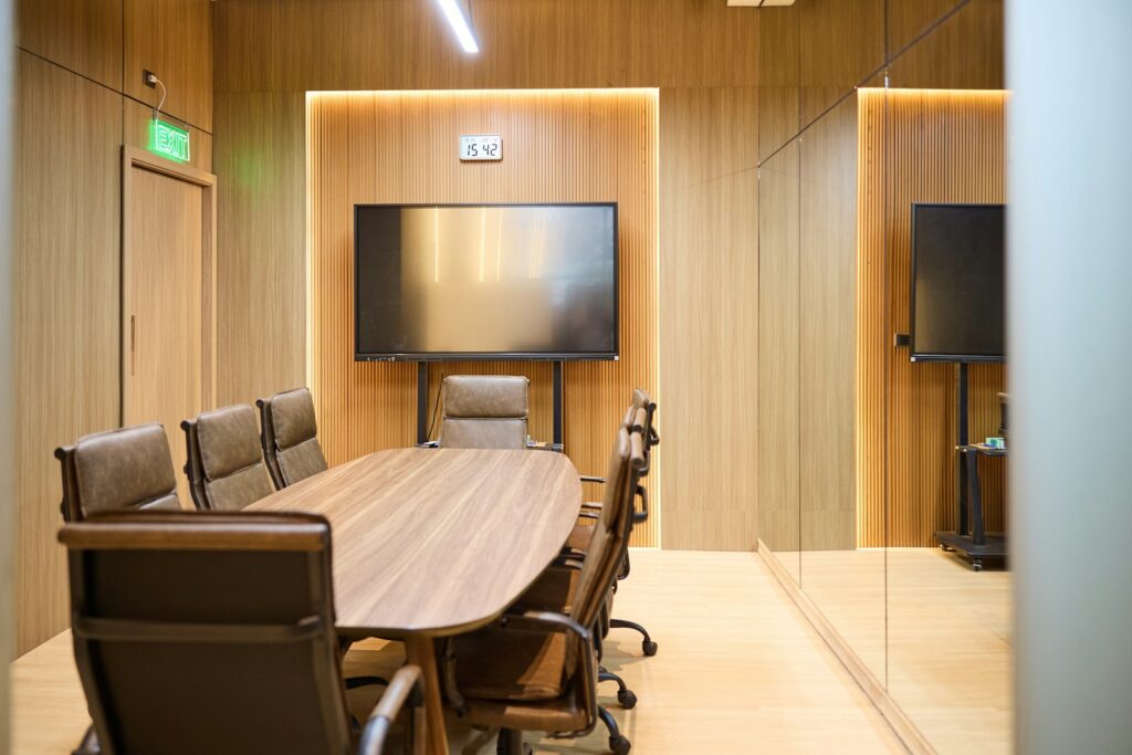 Modern conference room with an oval table and chairs, suited to board-level governance discussions